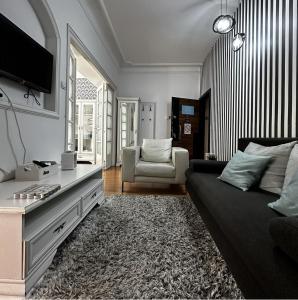 a living room with a couch and a tv at Bloom apartments in Belgrade