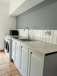 a kitchen with a sink and a counter top at Dolgellau Grand Heights Apt in Dolgellau