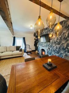 a living room with a wooden table and a fireplace at Dolgellau Grand Heights Apt in Dolgellau
