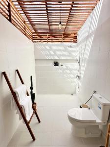 ein Badezimmer mit einem WC und einem Stuhl in der Unterkunft 2BR Pool Villa&Garden - Bali style by La Perla Phuket Rawai in Ban Saiyuan (1)