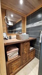 a bathroom with a sink and a mirror at Le refuge du poète in Saint-François-de-Sales