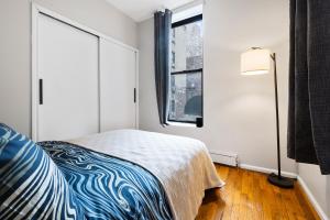 a small bedroom with a bed and a window at Experience the heart of Times Square in New York