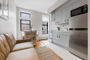 a living room with a couch and a kitchen at Experience the heart of Times Square in New York