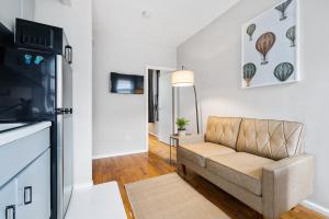 a living room with a couch and a television at Experience the heart of Times Square in New York