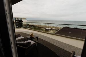 a room with a balcony with a view of the ocean at AVANGARDE SEA Luxury Apartments in Mamaia Nord