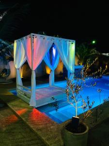 a lit up tent with a colorful at KEUR MATY Charmante et Moderne Villa 5 chambres, 5 salles de bains à Warang in Ouoran