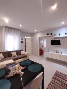 a living room with a couch and a table at La casa dei gelsomini in Alassio