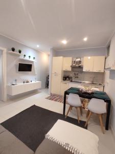 a kitchen with a table and chairs in a room at La casa dei gelsomini in Alassio +11 photos