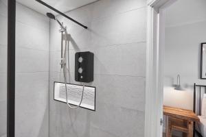 a shower with a black speaker in a bathroom at Roslyn House in Pateley Bridge +47 photos