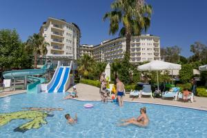 a group of people in the swimming pool at a resort at Mukarnas Spa & Resort Hotel in Okurcalar