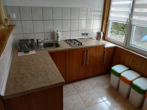 a kitchen with a sink and a counter top at Domek nad jeziorem Mazury Kobyłocha 13a in Szczytno