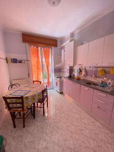 a kitchen with a table and a table and chairs at Affittacamere Benvenuti Monterosso in Monterosso al Mare