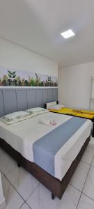 a bedroom with a large bed in a room at Iguassu Jungle pousada in Foz do Iguaçu