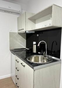 a kitchen with a sink and a counter top at Viva Apartments in Përmet