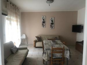 a living room with a table and a couch at Casa Petralia in Petralia Sottana