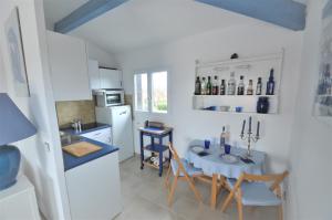 a kitchen with a table and a small table with chairs at Alamic in Grimaud