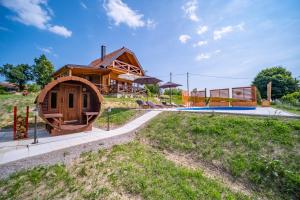 a large wooden house with a pool in front of it at Hižica Bubika in Karlovac