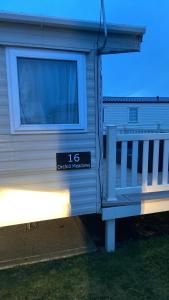 a blue and white trailer with a sign on it at Orchid meadows retreat in Ashington