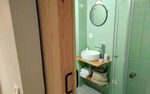 a bathroom with a sink and a mirror at O Refúgio do Pim in Horta +20 photos