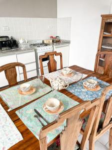 a kitchen with a wooden table with plates and dishes on it at 1876 in Chivilcoy +21 photos