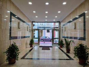 a hallway with plants and a car in a building at LMCM Canteras in Las Palmas de Gran Canaria