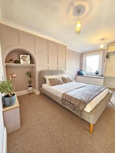 a bedroom with a large bed and a window at Seaview 2 bedroom apartment in Littlehampton