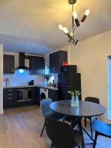 a kitchen with a table and chairs in a room at Modern City Centre Apartment in Dublin