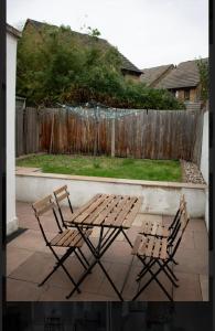 two chairs and a picnic table on a patio at Brentford Guest Rooms in Brentford