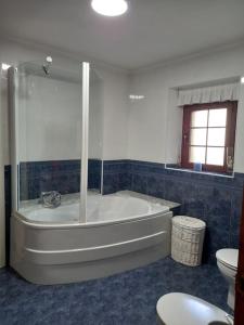 a bathroom with a bath tub and a toilet at Casa Pasiega in Renedo de Piélagos