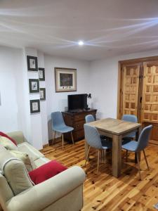 sala de estar con sofá, mesa y sillas en La casa sobre el rÍo, en Cuenca