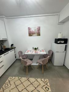 a kitchen with a table and chairs in a room at The moon view in Bucharest