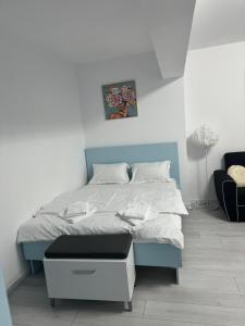 a bedroom with a bed with a blue headboard at The moon view in Bucharest