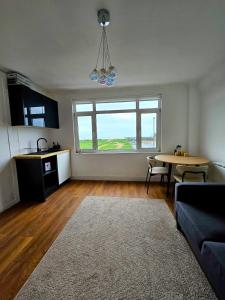 a living room with a couch and a table at Seaview 2 bedroom apartment in Littlehampton