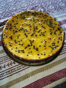 a cheesecake with cheese and black seeds on a table at VISTA CARIBE in Portobelo
