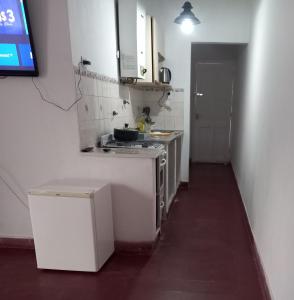 a small kitchen with white cabinets and a sink at Casa Eusebio - Catamarca capital in San Fernando del Valle de Catamarca