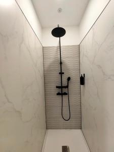 a bathroom with a shower with a shower head at Hostel Siesta & Go (Atocha) in Madrid +25 photos
