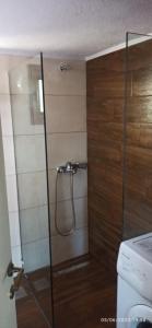 a shower with a glass door in a bathroom at Paradise house in Kriopigi
