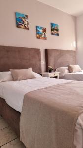 two beds sitting next to each other in a bedroom at LEVEL Mallorca - Living in Palma de Mallorca