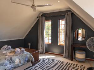 a bedroom with a bed and a mirror at Serenity Lodge in Clarens