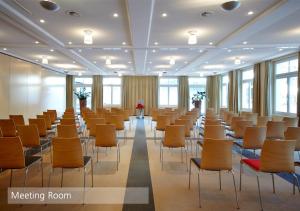 a large room with chairs and tables and windows at Lenkerhof gourmet spa resort - Relais & Châteaux in Lenk +106 photos