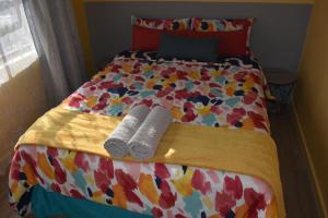 a bed with two pairs of socks on it at Gabby's apartment in Cape Town