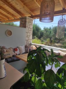 a living room with a couch and a table at Black Pearl Apartment Lithakia Zakynthos in Lithakia