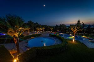 a view of a swimming pool at night at Penzión Aqua Maria in Veľaty