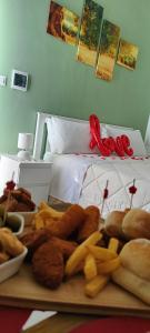 a tray of food on a table in front of a bed at KipoRooms in Zollino
