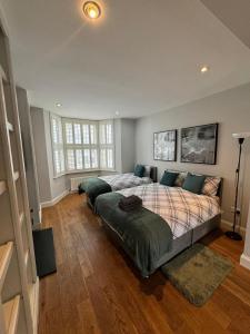 ein Schlafzimmer mit einem großen Bett und einem großen Fenster in der Unterkunft Brentford Guest Rooms in Brentford