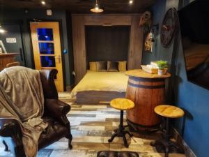 a bedroom with a bed and a table and a chair at The Pub - Unique & Authentic Experience - Free Parking!, 5 minutes from Airbus in Bristol