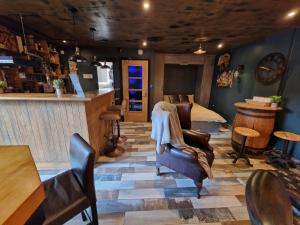 a room with chairs and a bed and a bar at The Pub - Unique & Authentic Experience - Free Parking!, 5 minutes from Airbus in Bristol