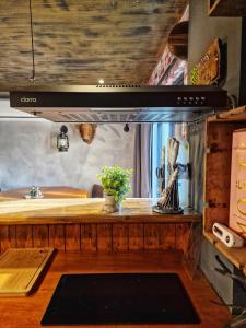 a kitchen with a counter with a stove top oven at The Pub - Unique & Authentic Experience - Free Parking!, 5 minutes from Airbus in Bristol