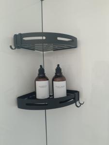 two bottles on a shelf in a wall at La pause bretonne in Quéven