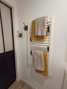 a bathroom with towels hanging on a wall at La pause bretonne in Quéven